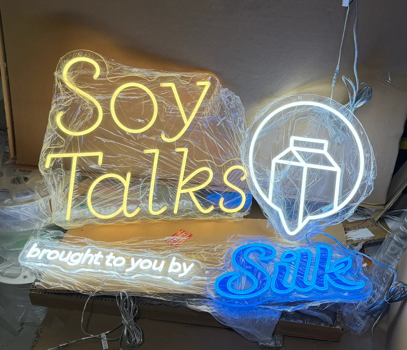 Completed Soy Talks, speech-bubble, sponsor and Silk neon sign pieces before shipping