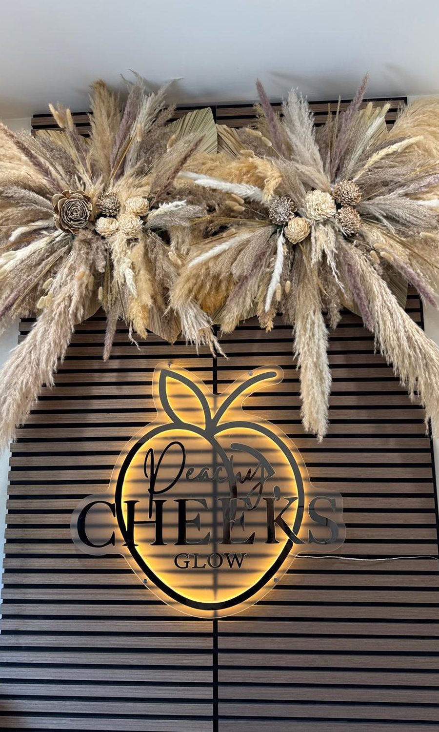 Peachy Cheeks backlit neon sign