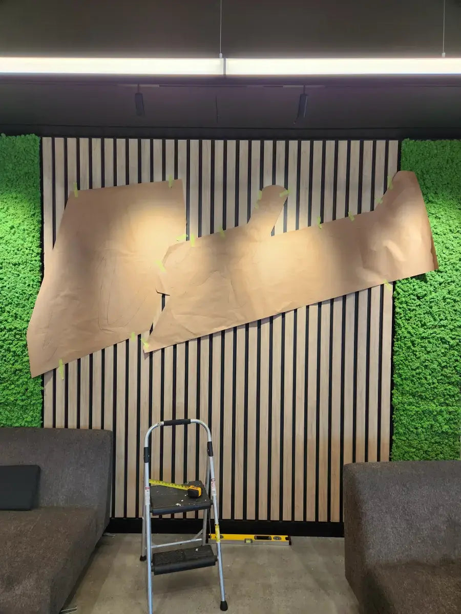 Step 1: kraft paper template taped to wall marking neon sign mounting points