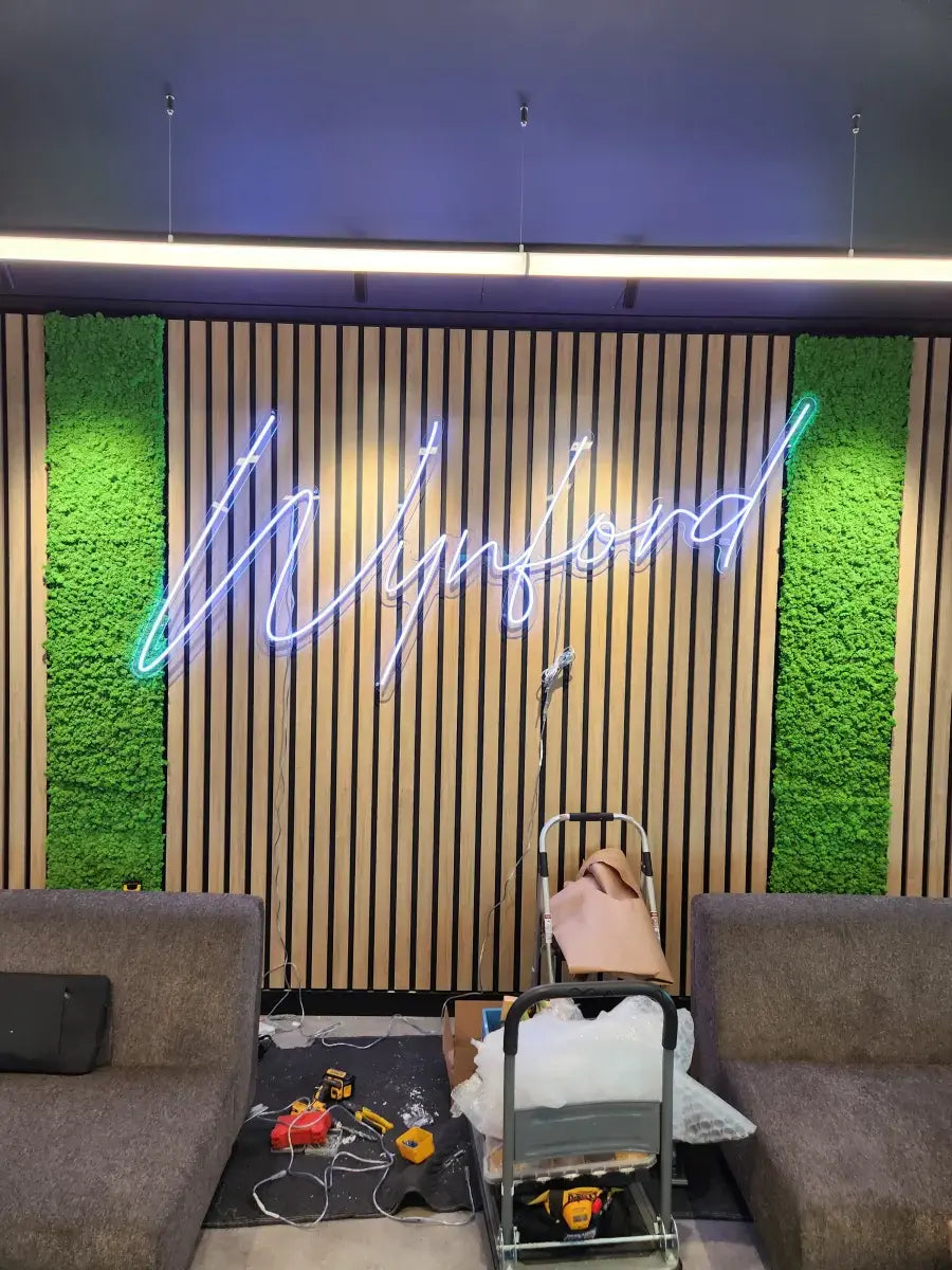 Step 3: neon sign being mounted to wall during professional installation